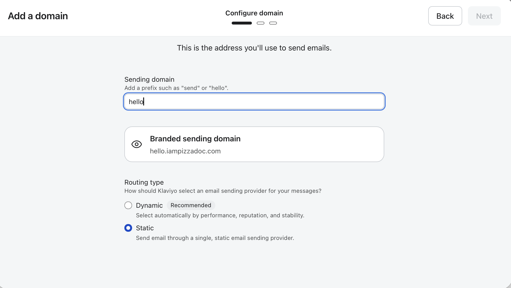 The Add a domain Configure domain screen shows the sending domain prefix set to “hello,” a branded sending domain preview, and Static routing selected. Visible: Add a domain, Configure domain, Back, Next, This is the address you'll use to send emails., Sending domain.